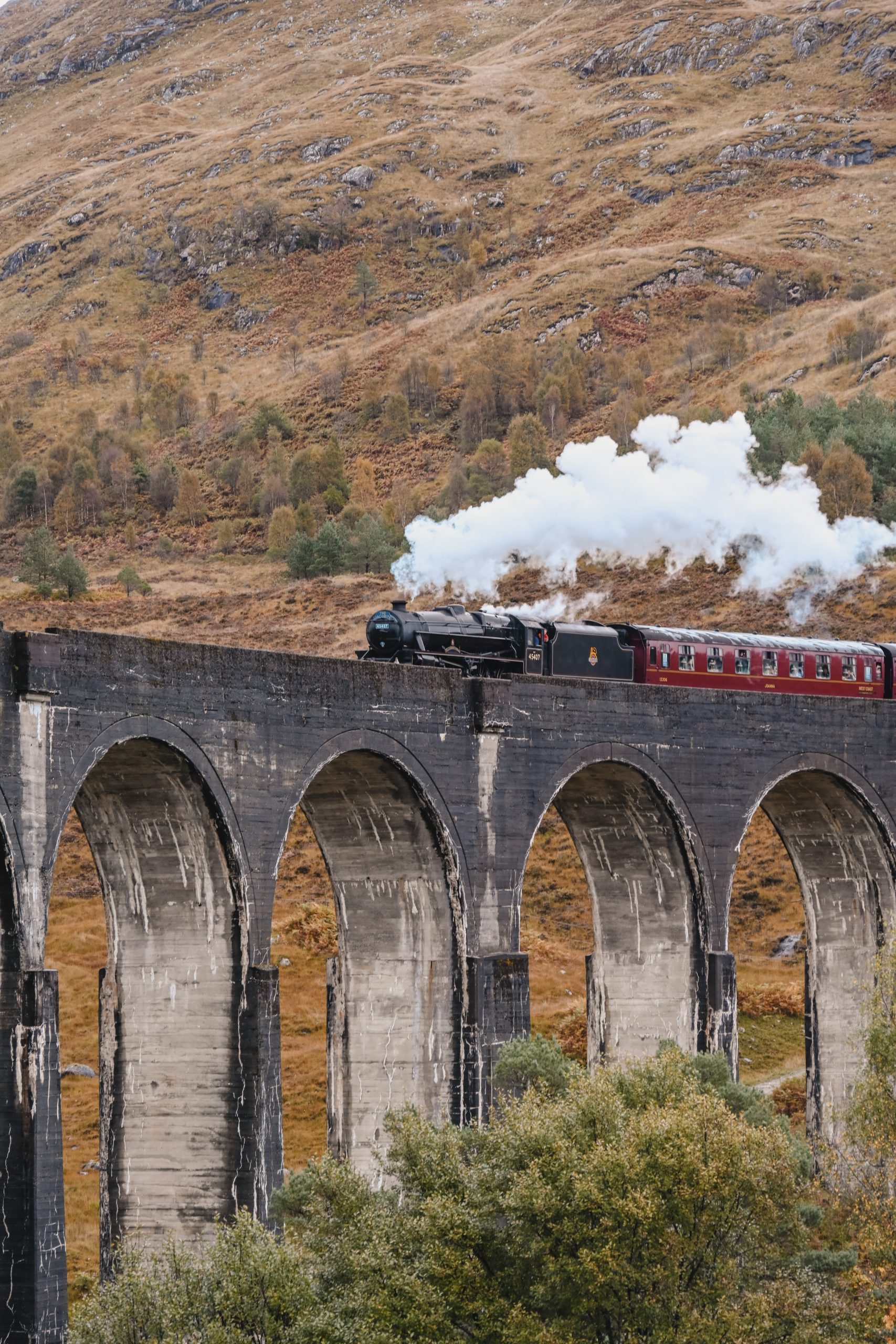 The Jacobite Express travels over Glenfinnan Viaduct, near Fort William