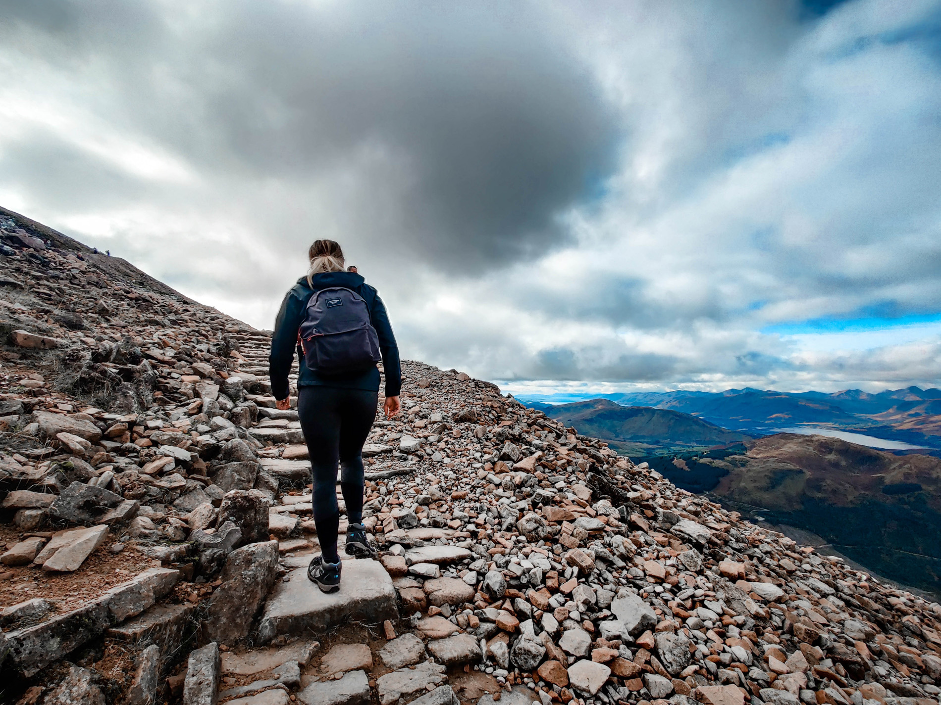 woman climbing Ben Nevis as part of a Scotland road trip